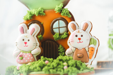 Gingerbread cookies in the shape of cute Easter bunny decorated with festive icing on the white background