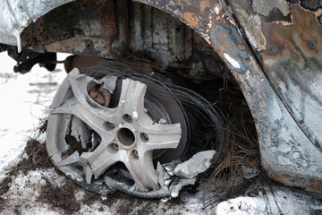 Burnt car with small flames inside of the engine. Burnt new car. malfunction that led to the death...