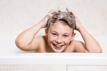 Happy bathing baby with foam on his head
