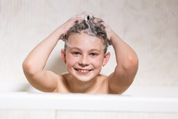 Happy bathing baby with foam on his head