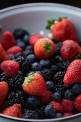 berries in white antique strainer