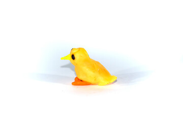 A small yellow chick. Plasticine bird on white background.