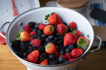 berries in white antique strainer