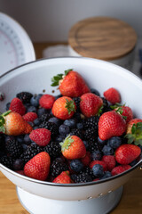 berries in white antique strainer