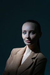 Portrait of a sly woman in a low key. Business portrait.