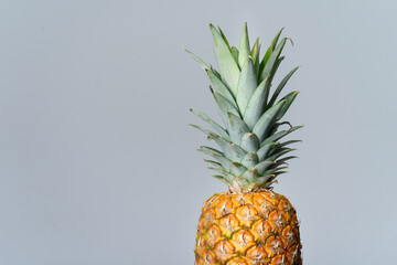 Juicy ripe pineapple. Isolated on a gray background. Diet and vitamin D.
