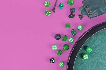 Different green roleplaying dices on purple background