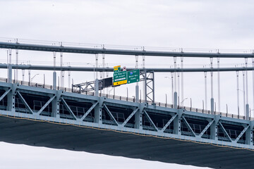Road signs on the upper level of the Verrazano Narrows Bridge between Brooklyn and Staten Island,...