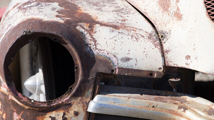 Old rusty car with rusty hood and chrome