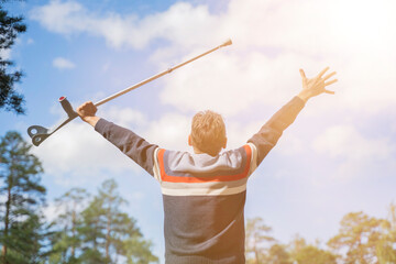a disabled man with a walking stick rejoices in healing recovery