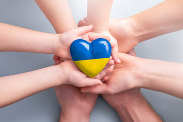 The adult and the child holding Ukraine heart.