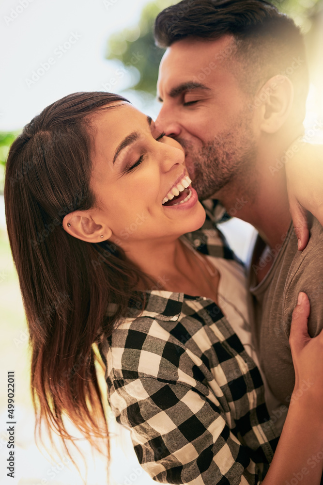 Poster Love can brighten any day. Shot of an affectionate young couple bonding at home.