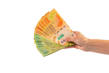 hand holding a fan of Argentinean money, white background, space for copy, business concept