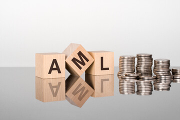 AML - the text is made up of letters on wooden cubes lying on a mirror surface