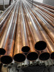 copper pipes stacked on a rack in a warehouse