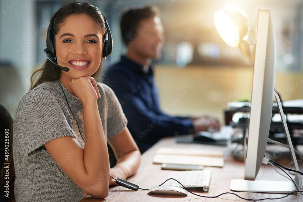 Wall mural Happy to be assisting customers. Shot of young agents working in a call center.