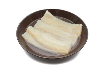 Cod in soak, to desalt. To make a widely consumed meal during Easter, in Spain, chickpeas with cod. Isolated on white background. Spanish traditional foods.