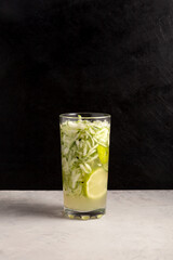 Es Timun Serut or Le Both Timon. Indonesian Refreshment Drink based on cucumber with lime and sweet basil seeds. Popular during ramadan. Dark background, copy space