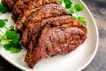 Grilled Picanha Steaks Served on a Platter: Grilled picanha steaks arranged on a large serving plate