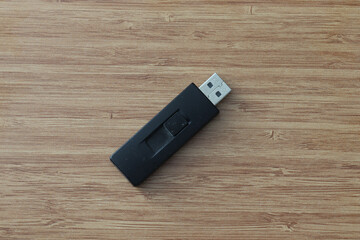 USB Stick on wooden background.