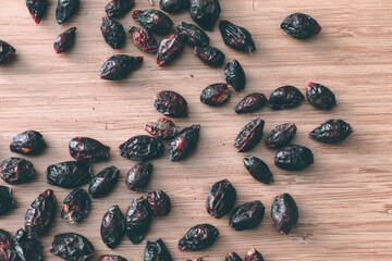 Rosehips on a wooden bakcground.