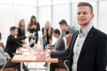 confident business man standing in the office
