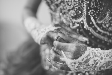 Indian bride's hands, gloves, rings, mehendi and jewellery close up