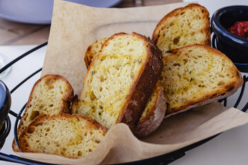 Basket with delicious fresh bread with herbs