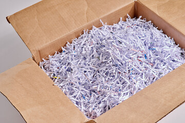 Shredded paper is great for packing. Studio shot of shredded paper in a cardboard box against a...