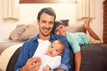 Obraz premium Its just me and my boys today. Cropped portrait of a handsome young dad and his two sons spending quality time together at home.