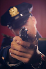 Police Officer pointing a handgun, direct view