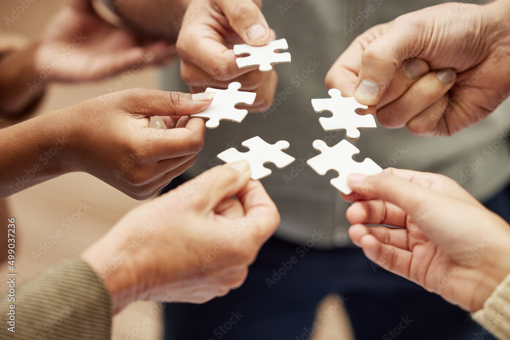 Aufkleber Problem solving as a team for optimum efficiency. Closeup shot of a group of unrecognisable people joining puzzle pieces together.