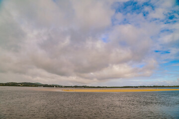 Group of pelicans and seagulls sitting on exposed sand bar in the Forster-Tuncurry lakes region, NSW Australia