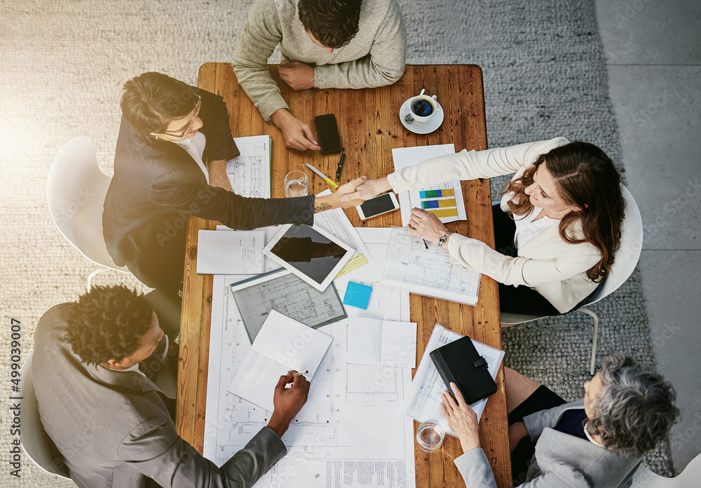 Aufkleber theres a new addition to the team. high angle shot of businesspeople shaking hands during a meeting 