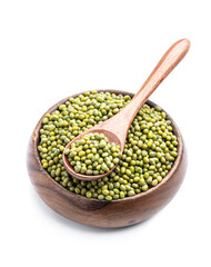 Raw green mung beans in wooden bowl isolated on white