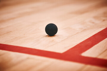 So much performance power in one tiny ball. Shot of a squash ball on the floor of a squash court.