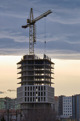 Fototapeta na wymiar Tower cranes at high residential apartment buildings construction site. Real estate development