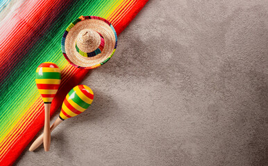 Cinco de Mayo holiday background made from maracas, mexican blanket stripes or poncho serape and...