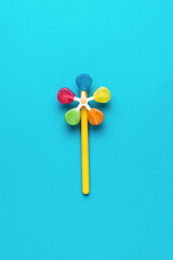 Several colored lollipops on a blue background. Flat lay.