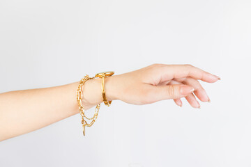 women hand with a chain bracelet and a watch, manicure,