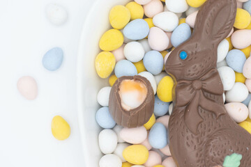 Chocolate bunny with cadbury creme egg on top of candy eggs
