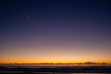 Sunrise Quarter Moon Over Ocean Walker Orange and Dark Blue Sky Surf Beach Gold Coast Australia