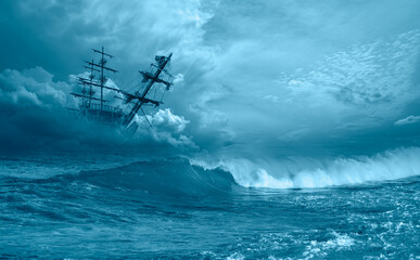 An old sailing ship in the mist sails towards the rocks - Sailing old ship in a storm sea in the...