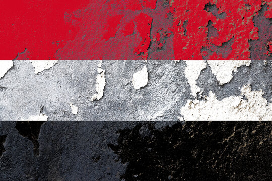 Yemen flag painted on a damaged old wall surface