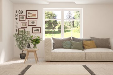 White living room with sofa and summer landscape in window. Scandinavian interior design. 3D illustration