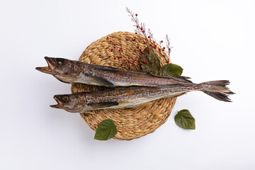 Two dried pollock on a white background viewed from above