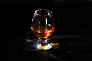whiskey glass on a black background