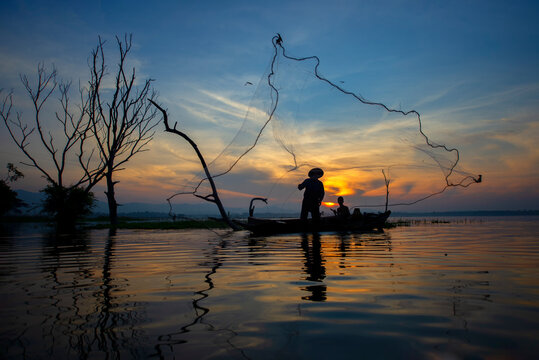Fisherman of Bangpra Lake in action when fishing, Thailand