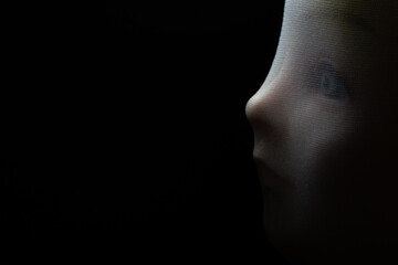 A girl doll isolated on black background with copy space.