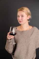 studio portrait of a girl with a glass of wine